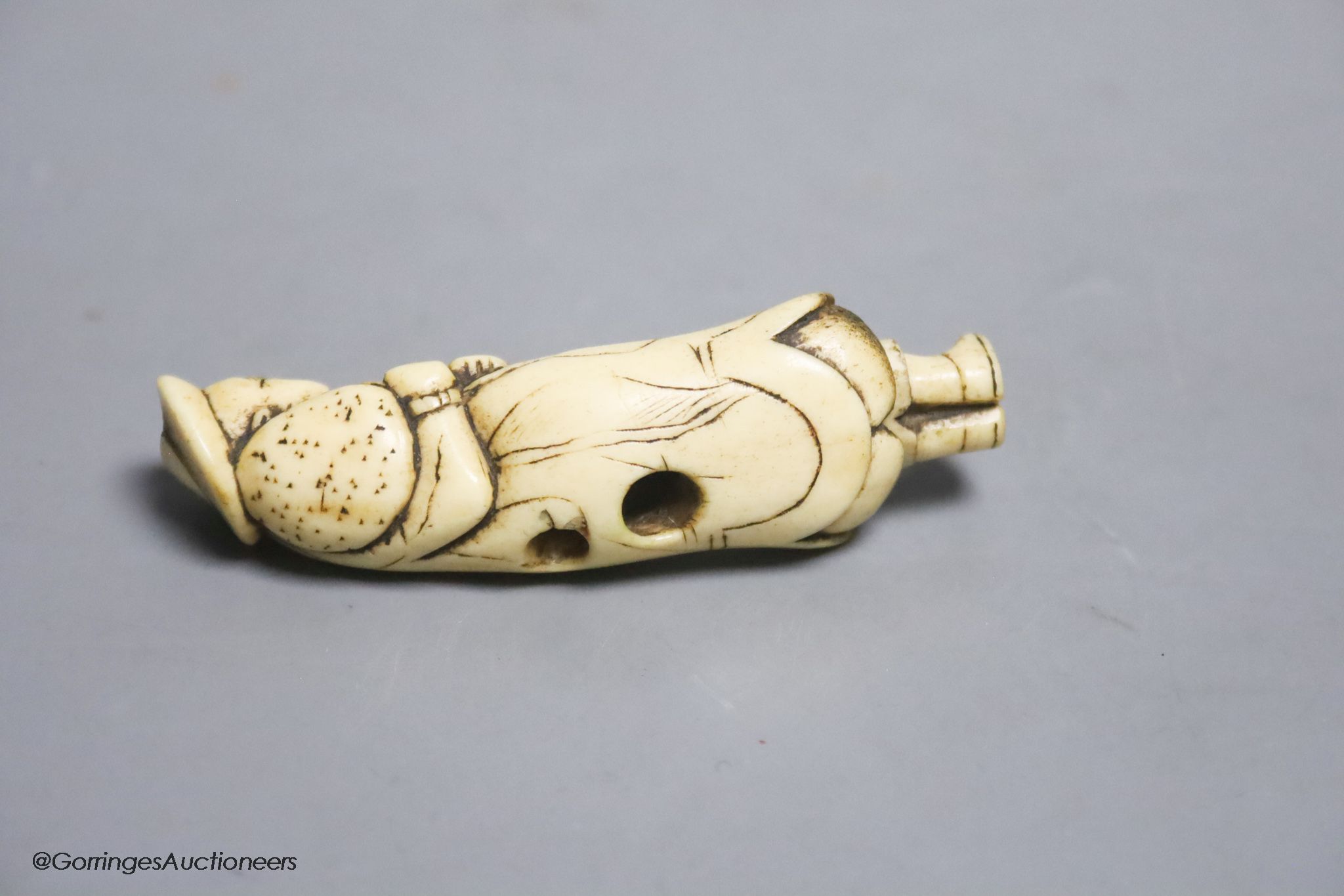 An 18th century Japanese stag antler netsuke of a Dutchman, 7cm